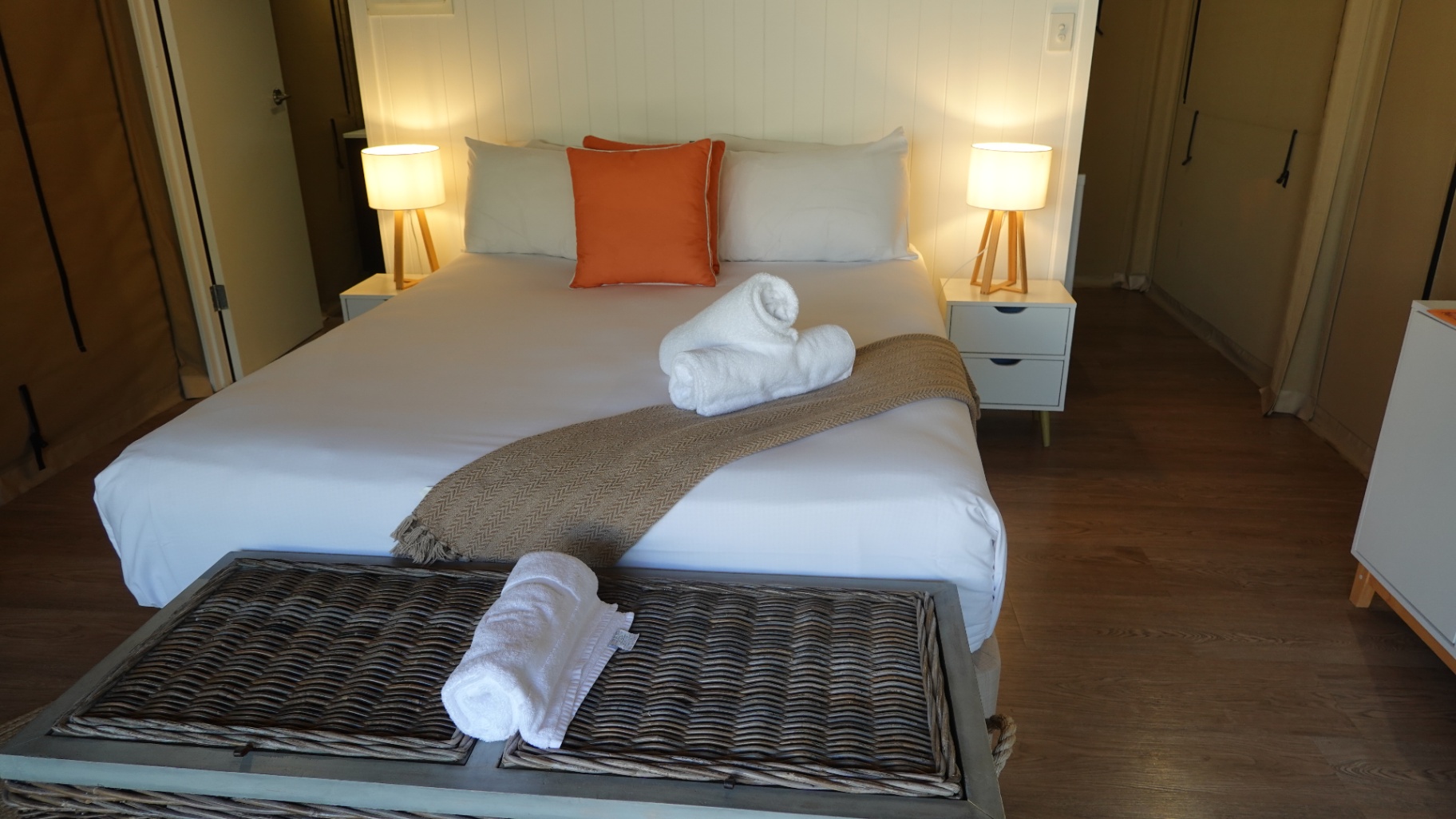 King bed in a Magnetic Glamping safari tent dressed in quality white linen, Magnetic Glamping safari tent