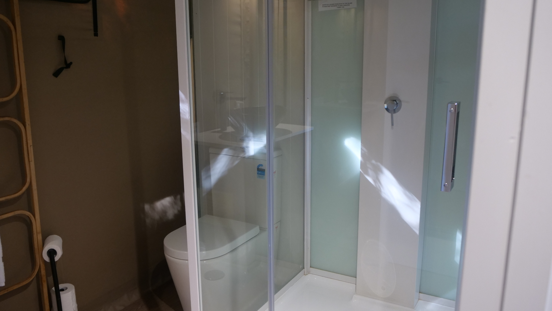 Private shower in a Magnetic Glamping tent — fresh towels and quality fittings