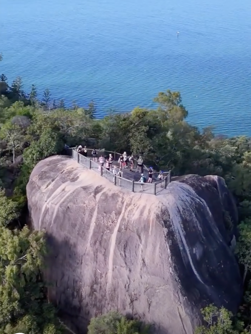 Walkers on a granite lookout above the Coral Sea on one of Magnetic Island's headland trails