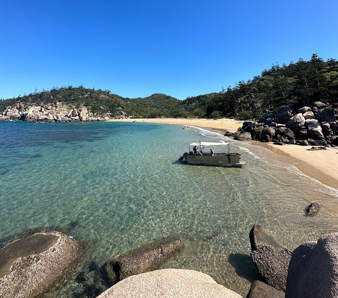Boat at anchor on a pristine Magnetic Island beach
