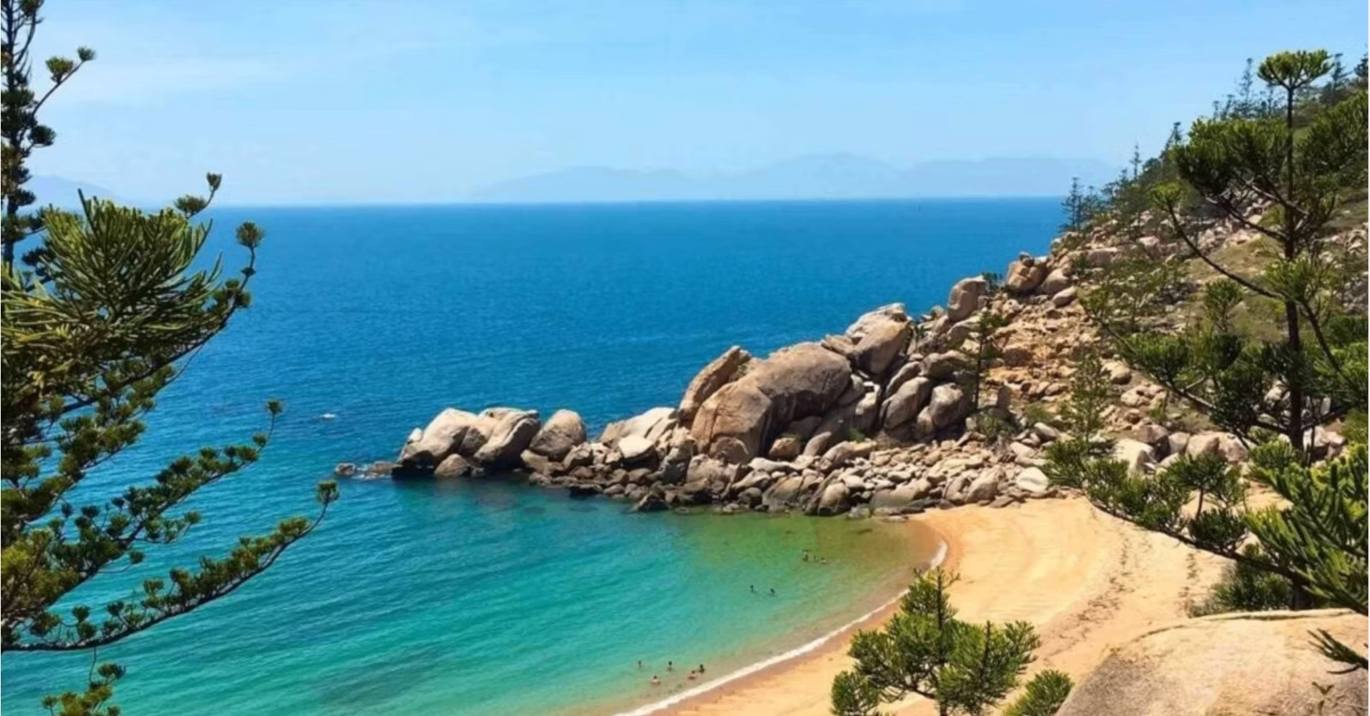 Secluded cove with granite boulders and clear water