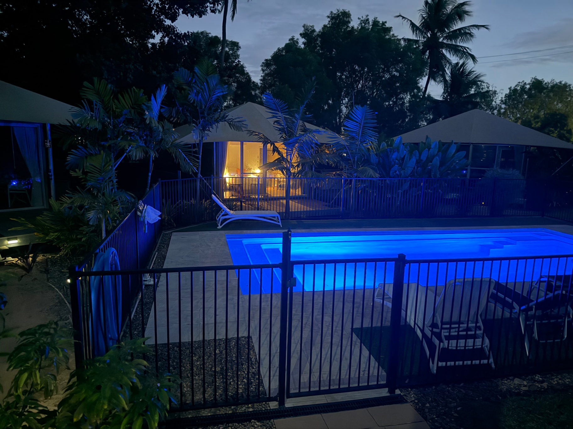 The magnesium pool at Magnetic Glamping reflects a blazing tropical sunset