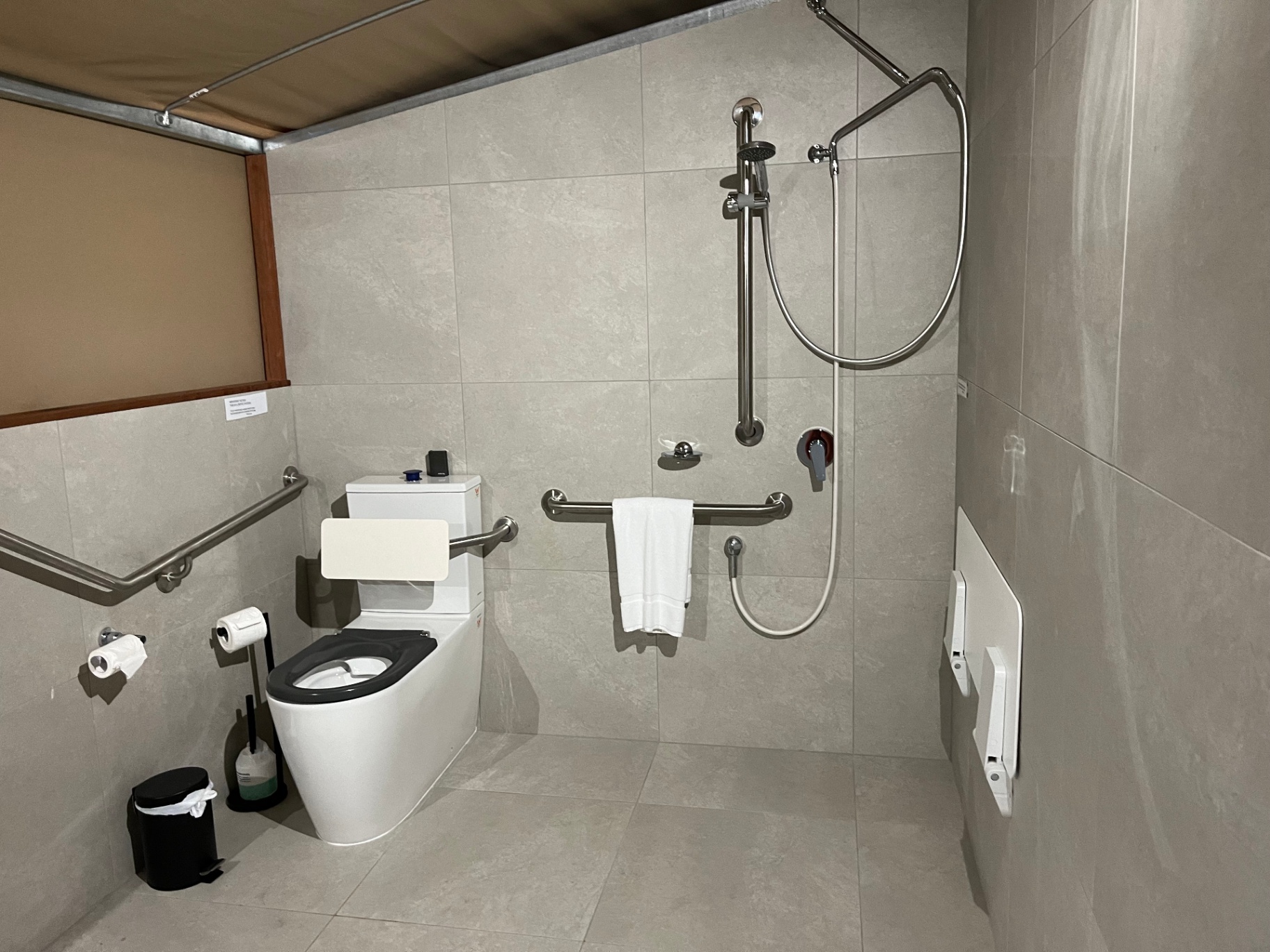 Tent 7 accessible bathroom — roll-in shower, grab rails and raised toilet, Magnetic Glamping