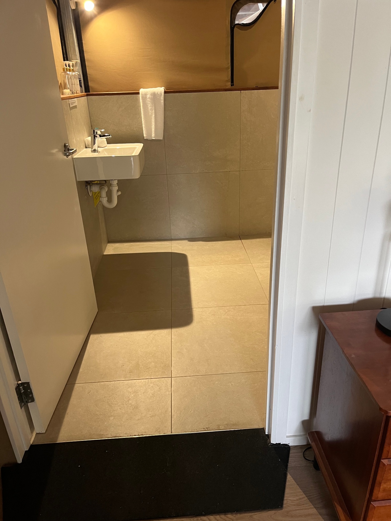 Accessible ramp with handrail from the Tent 7 deck to the private bathroom